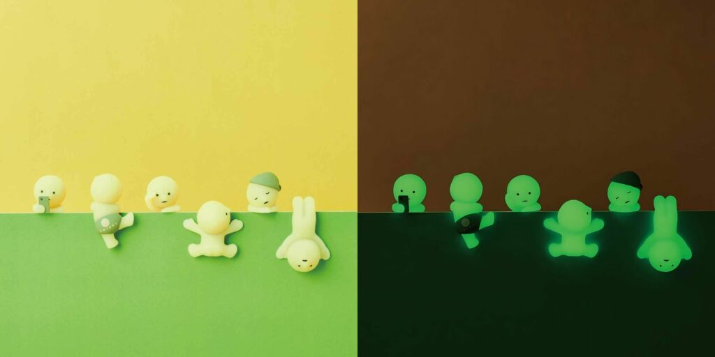 Glow-in-the-dark smiski figure set showcasing playful poses in daylight and illuminated at night. Perfect for collectors.