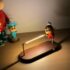 Whimsical desk lamp with cartoon character design and wooden base for playful home decor lighting.