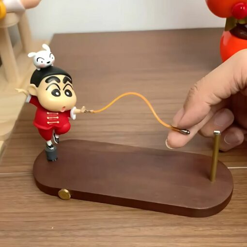 Toy figurine on wooden base with interactive skipping rope, featuring cute character design for desk decor.