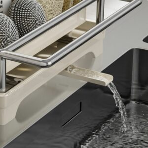 Expandable dish rack with water drainage spout over sink, featuring stainless steel frame and space for kitchen accessories.